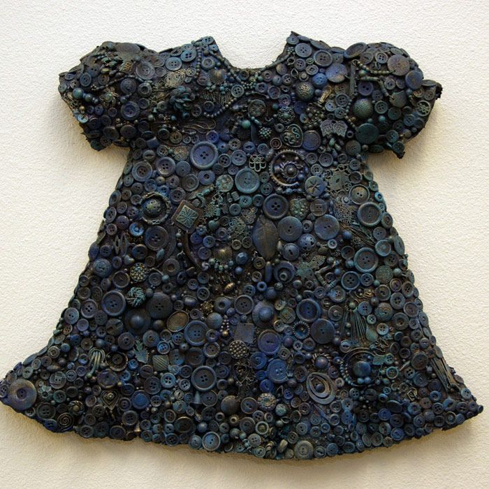 a blue dress made of buttons and gears